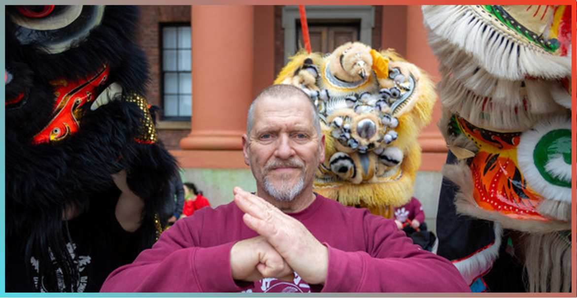 picture of Stephen Ornellas flanked by Chinese Lion heads