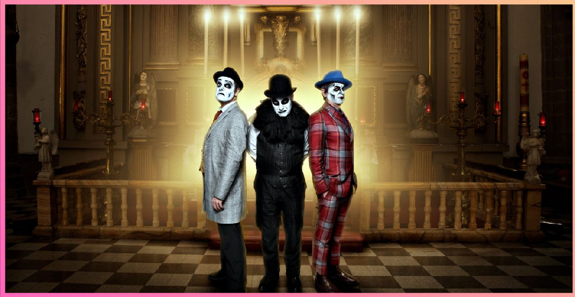 Three characters with clown facepaint stood in a grand room.