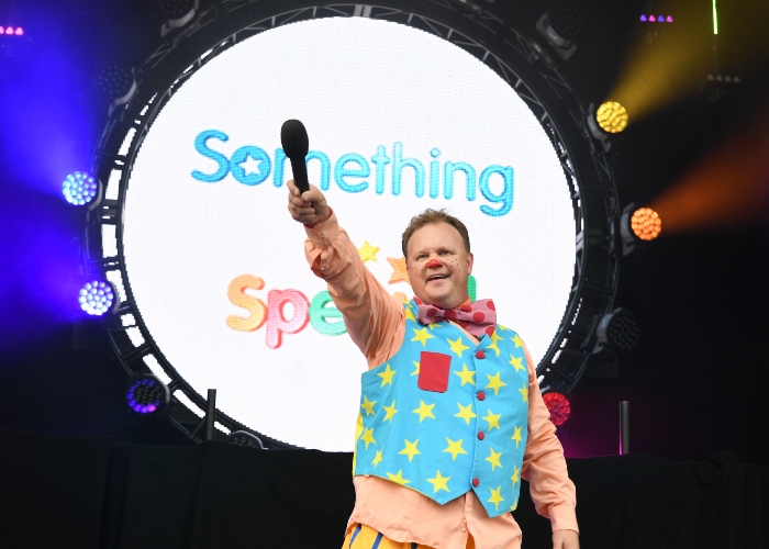 Mr Tumble from Cbeebie performing on stage in front of a large crowd in Croxteth Park, Liverpool