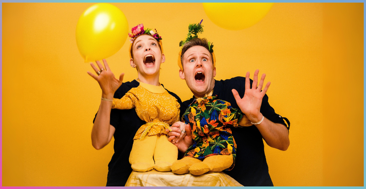 Two actors dressed as Shakespearen characters in a yellow room.