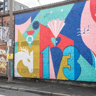 A bright, colrouful mural depciting '13' in blue colours.