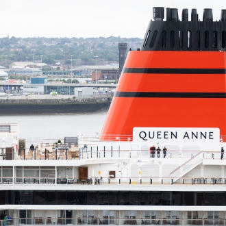 A close up image of Cunard Queen Anne ship docked in Liverpool on an overcast day.