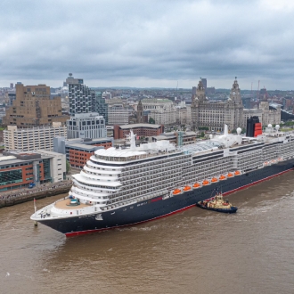 An image of Cunard Queen Anne ship docked in Liverpool on an overcast day.