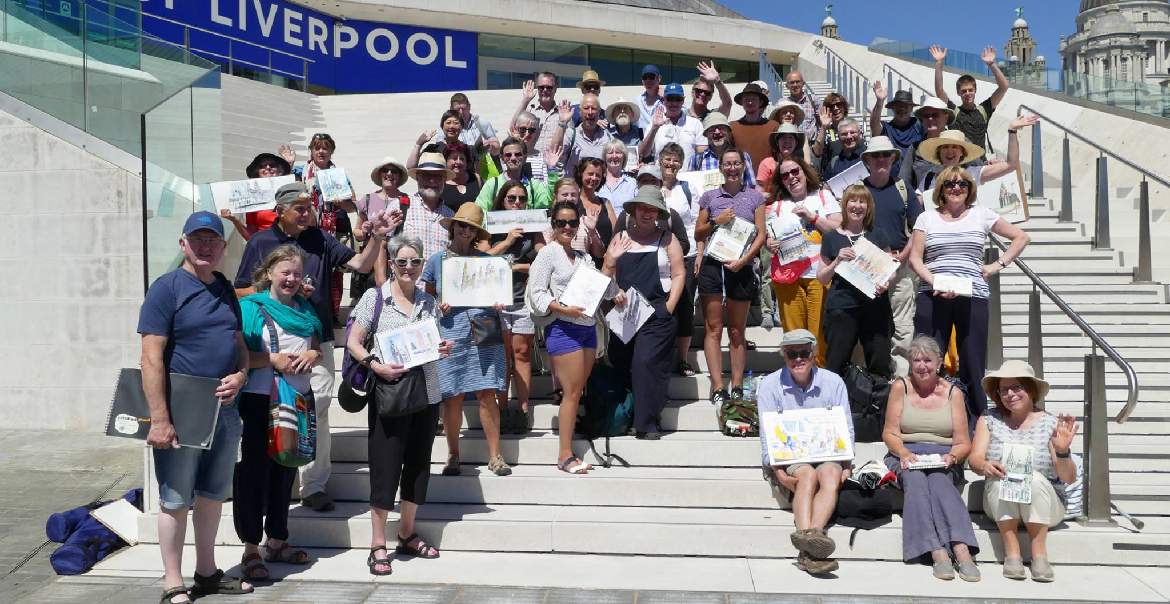 A group of people standing on the exterior steps of Museum of Liverpool, each person holding up their artwork