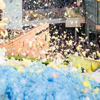 An explosion of colourful foam on Sugar House Steps, Liverpool ONE on a sunny day.