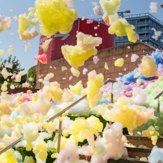 An explosion of colourful foam on Sugar House Steps, Liverpool ONE on a sunny day.