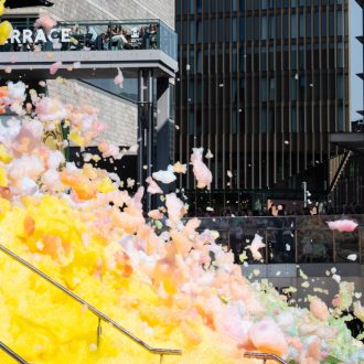 An explosion of colourful foam on Sugar House Steps, Liverpool ONE on a sunny day.