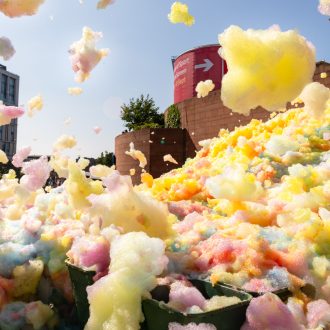 An explosion of colourful foam on Sugar House Steps, Liverpool ONE on a sunny day.