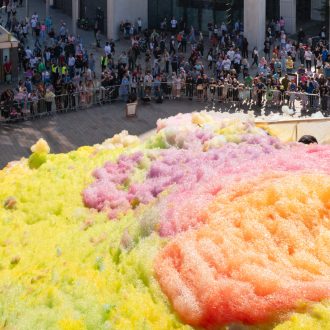 An explosion of colourful foam on Sugar House Steps, Liverpool ONE on a sunny day.