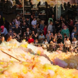 An explosion of colourful foam on Sugar House Steps, Liverpool ONE on a sunny day.