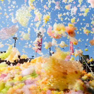 An explosion of colourful foam on Sugar House Steps, Liverpool ONE on a sunny day.